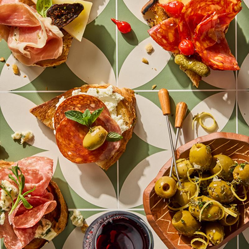 Assorted meats with spread, bread, olives and cheese
